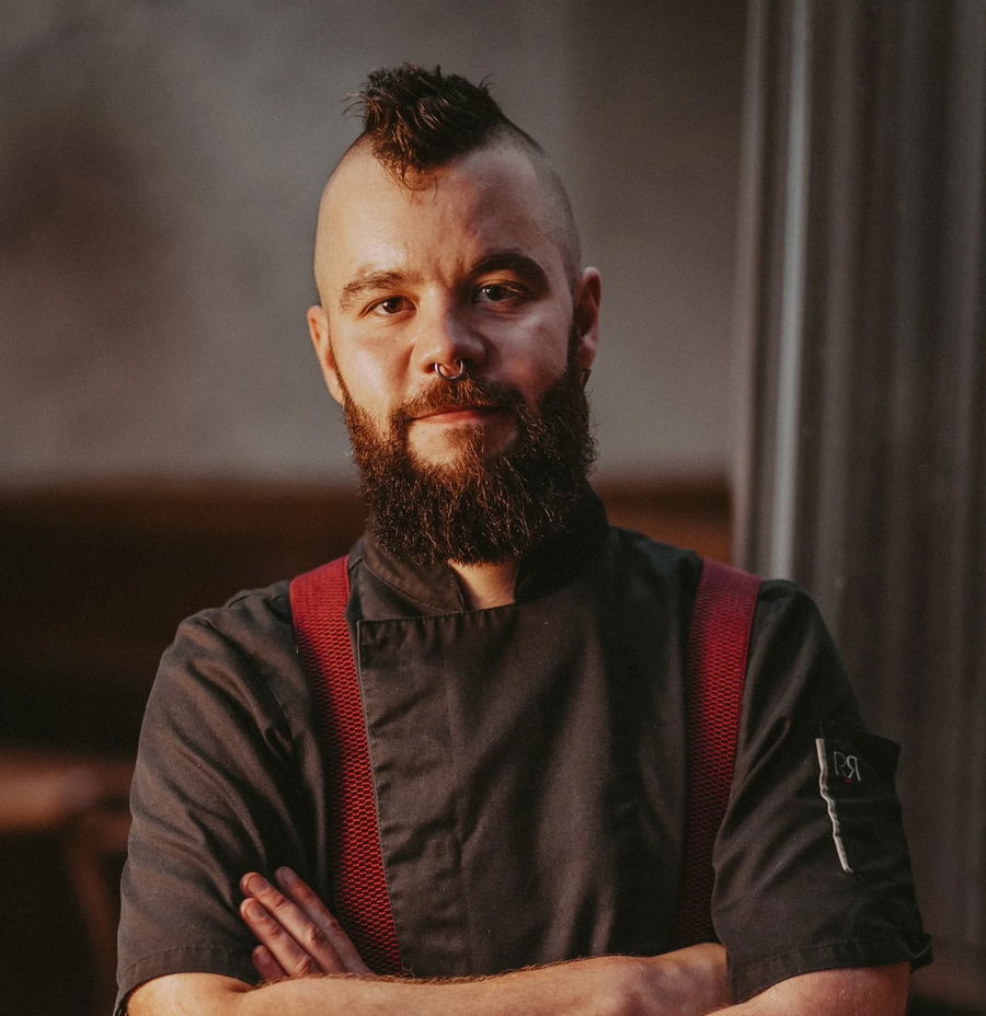 Alexis Petit in chef whites, arms crossed.